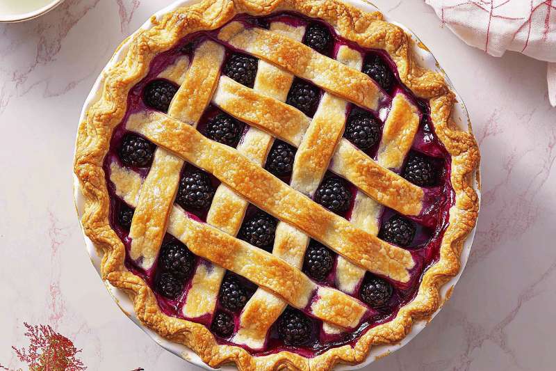 A freshly baked blackberry pie with a golden lattice crust and juicy blackberry filling